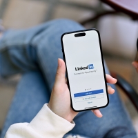 Person looking at the LinkedIn app on a smartphone 
